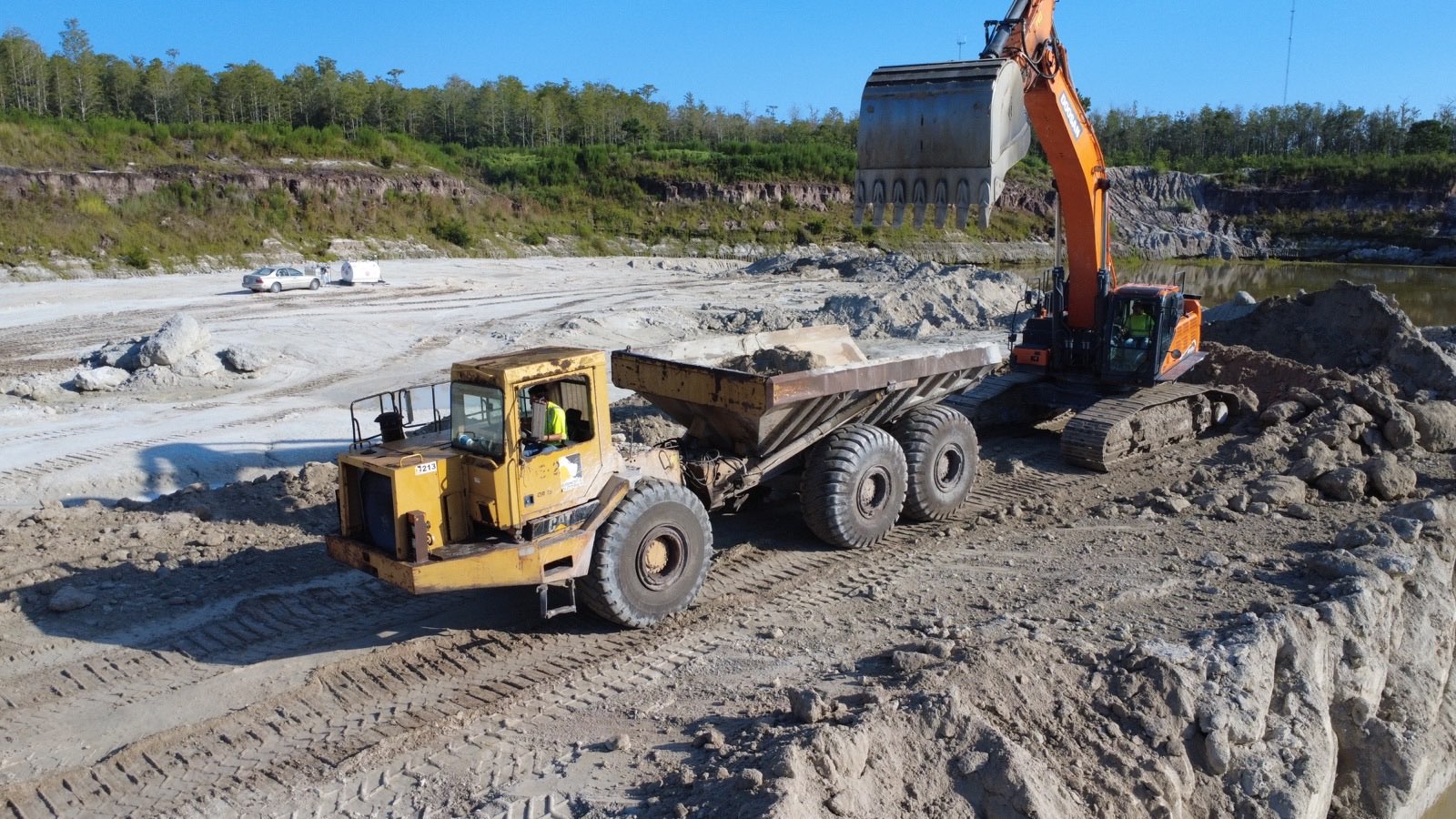 Aerial view of truck loading operations at excavation site in Central Florida